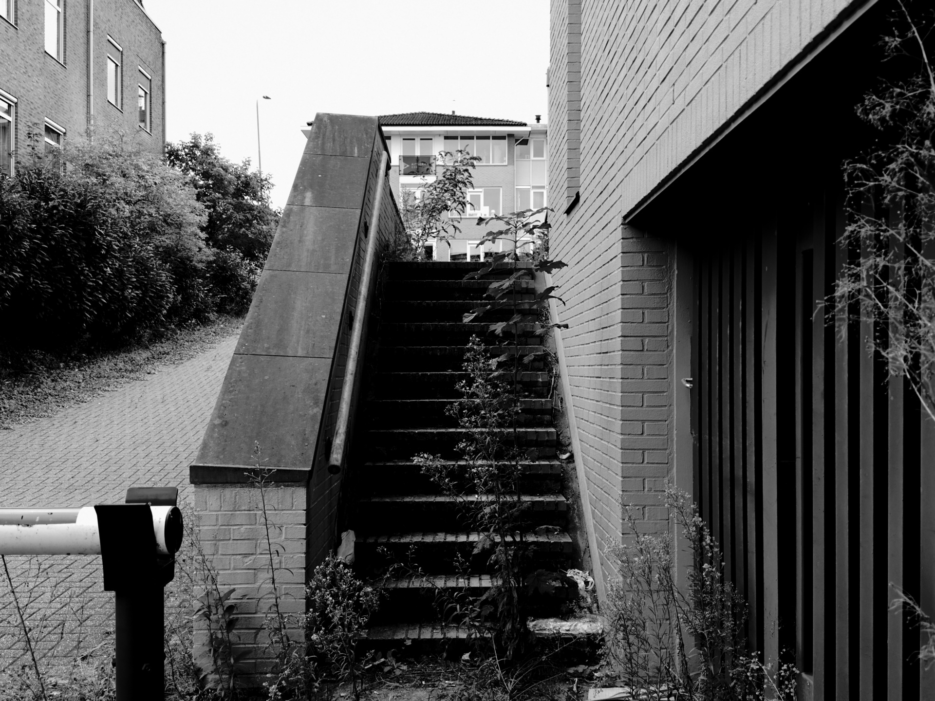 Concrete exterior staircase between two buildings.